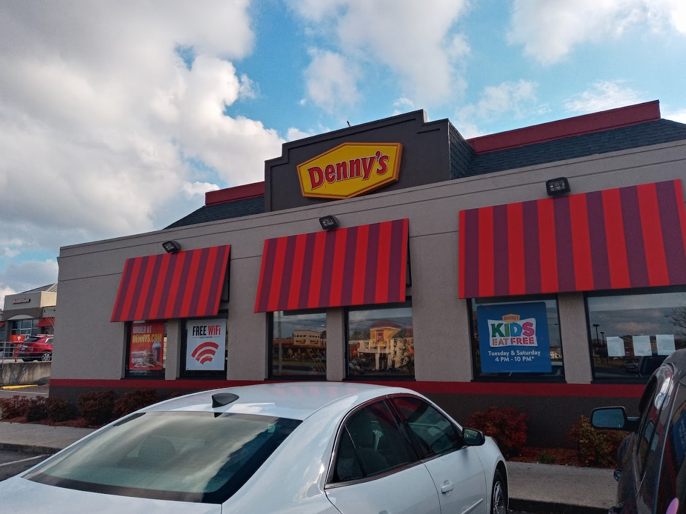 Outside the front door of a Denny's diner location that's open to serve breakfast, lunch, and dinner. Outside the front door of a Denny's diner location that's open to serve breakfast, lunch, and dinner.
